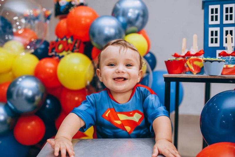 6 months birthday of a baby wearing superman t-shirt
