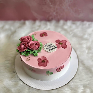 pink and white cake with flowers