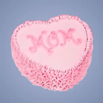 Heart-shaped pink Mother’s Day cake with “MOM” written in decorative icing