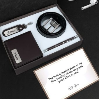 A gift box with wallet, belt, pen, and keychain