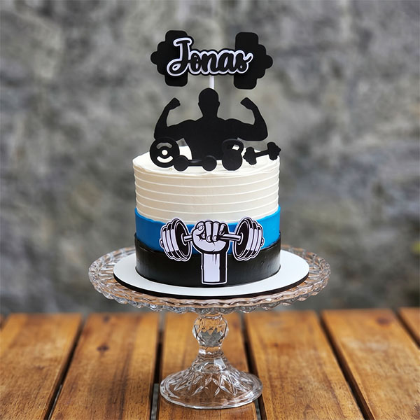 White, blue, and black striped cake with weightlifter silhouette and custom name topper.